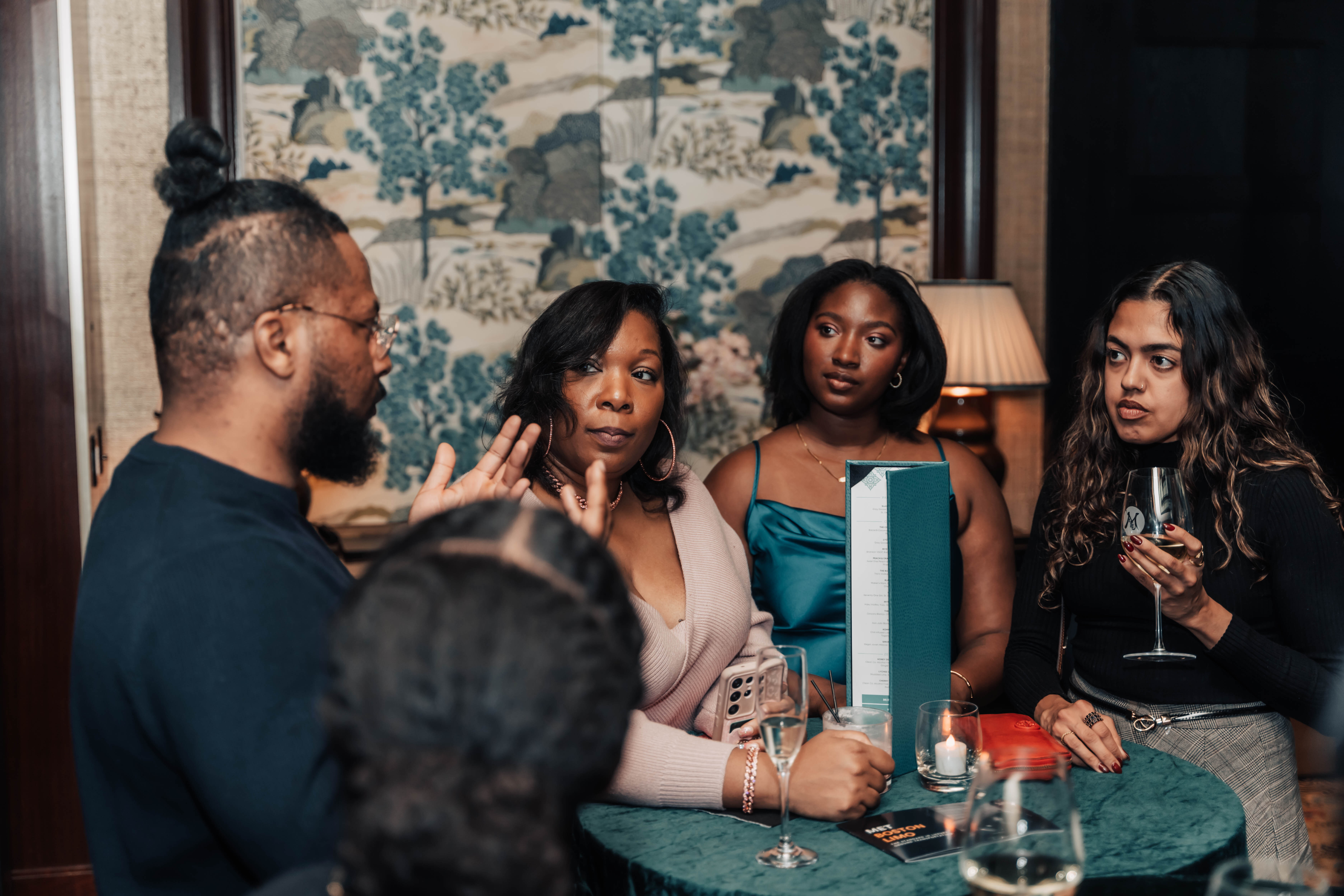 A small group in conversation at a private EA Society dinner.